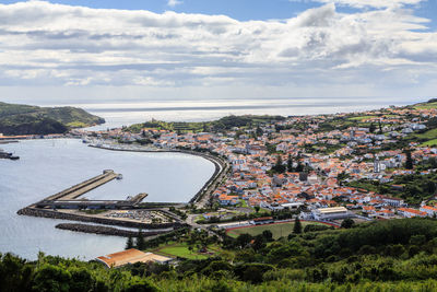  high angle view of cityscape and harbor against the sky