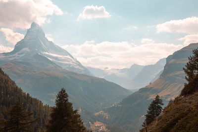 Scenic view of mountains against cloudy sky