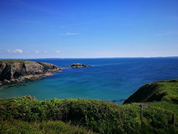 Scenic view of sea against blue sky