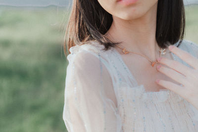 Midsection of woman standing against blurred background