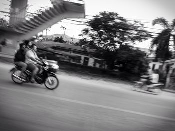 Blurred motion of people walking on road