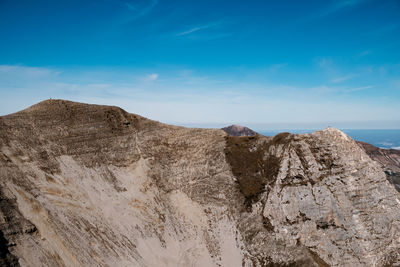 Scenic view of rocky mountains against blue sky in arquata del tronto, marche italy 