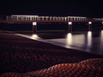 Illuminated bridge at night