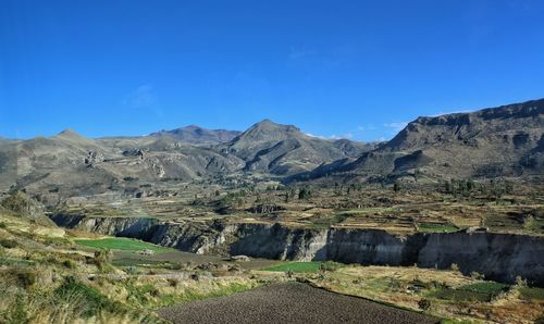 Scenic view of mountains against clear blue sky