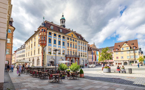 People on street amidst buildings in town