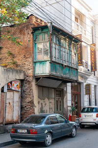 Cars on street by old buildings