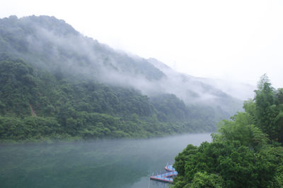 Scenic view of river amidst mountains against sky