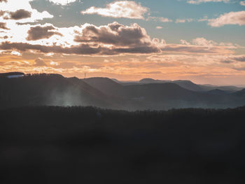 Scenic view of silhouette mountains against sky during sunset