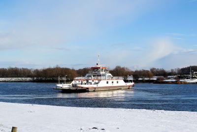 Boat sailing in river during winter
