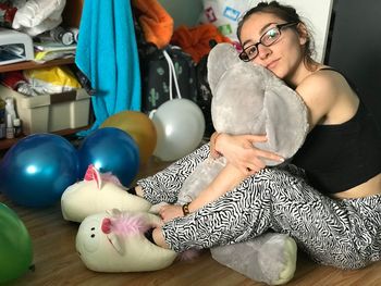 High angle view of woman holding balloons at home
