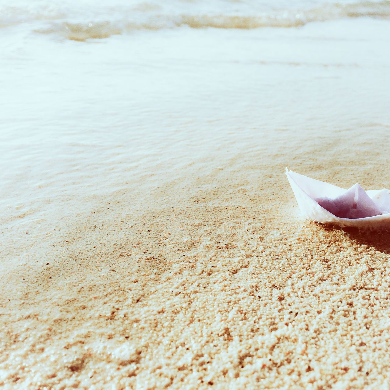 water, sand, beach, sea, shore, nature, high angle view, tranquility, rippled, day, outdoors, tranquil scene, beauty in nature, wave, sunlight, animal themes, one person, surf, coastline, part of