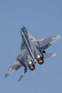 Low angle view of fighter plane flying in sky