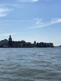 View of sea and buildings against sky