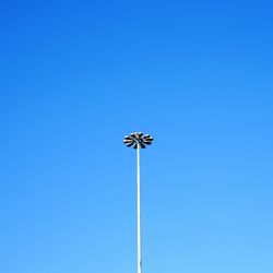Low angle view of street light against clear blue sky