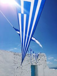 Umbrella on beach against blue sky on sunny day