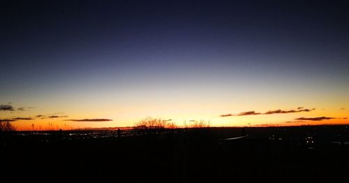 Silhouette landscape against sky during sunset