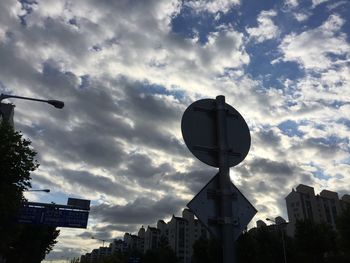 Low angle view of building against cloudy sky