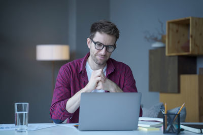 Young woman using laptop at table