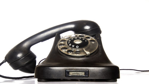 Close-up of telephone booth against white background