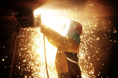 Man working on fire at night