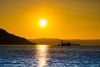 Scenic view of sea against orange sky