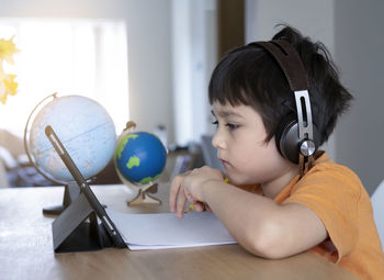 Boy having video call on table at home