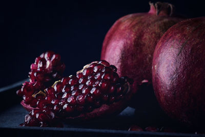 Close-up of fruits on table against black background