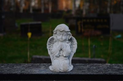 Close-up of angel statue in cemetery