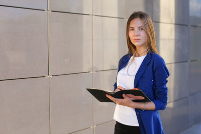 Portrait of young woman using mobile phone