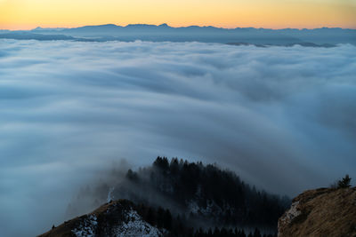 Scenic view of snowcapped mountains against sky during sunset