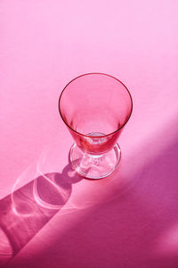 Close-up of water drops on glass against pink background