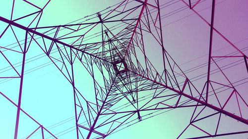 Low angle view of electricity pylon against clear sky