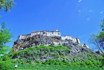 Low angle view of built structure against clear blue sky