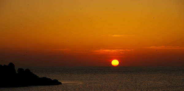 Scenic view of sea at sunset