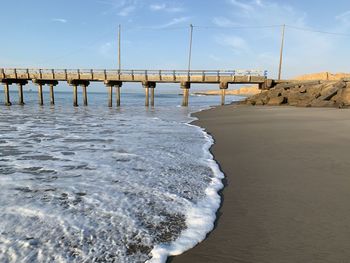 Pier over sea against sky