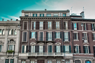 Tradition italian style building with balconies on the streets of milan