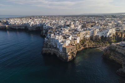 Italy, puglia, polignano a mare, aerial view of coastal old town