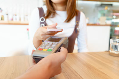 Midsection of woman using mobile phone