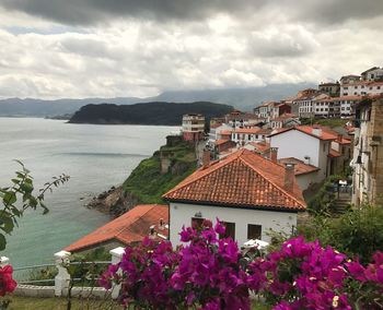 Scenic view of sea and buildings against sky