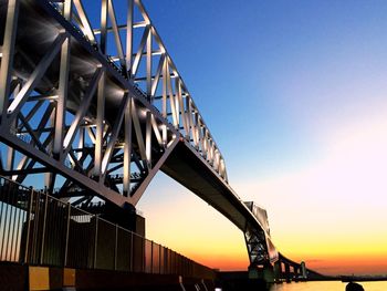 Low angle view of tokyo gate bridge against sky during sunset
