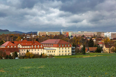 Houses on field against sky