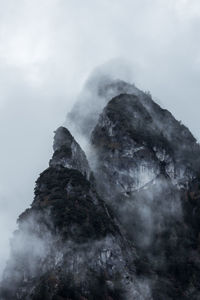 Low angle view of rock formation against sky