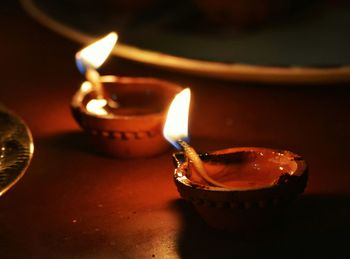 Close-up of lit candles on table