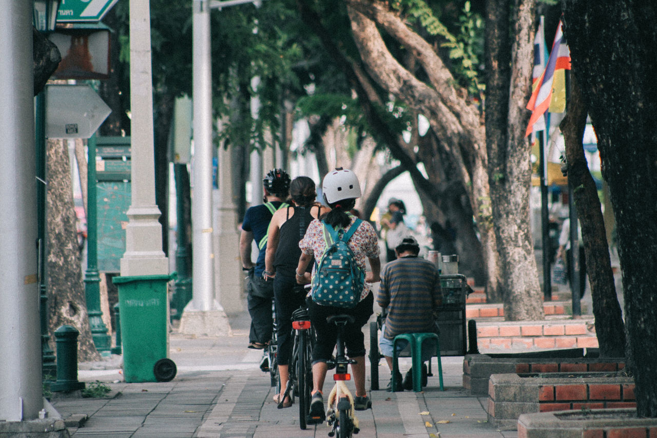 GROUP OF PEOPLE WALKING ON PATHWAY