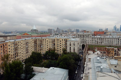 View of cityscape against cloudy sky