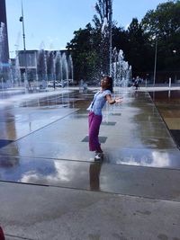 Full length of girl playing in water