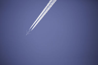 Low angle view of airplane flying in sky