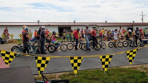 People on bicycle against sky