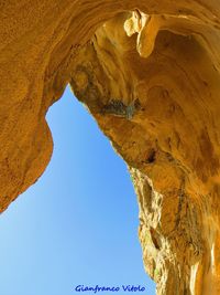 Low angle view of rock formation against sky