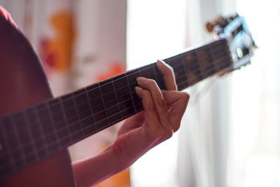 Close-up of hand playing guitar